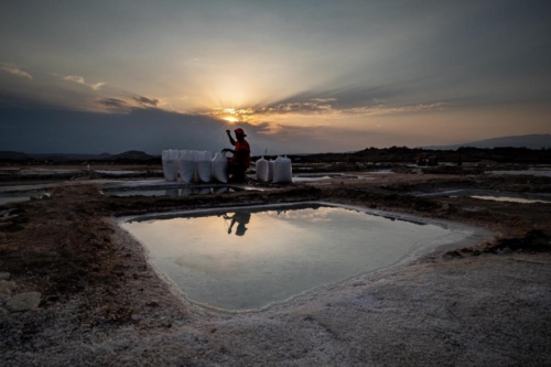 Final working hours during sunset at Quriyat Salt Pans in Oman